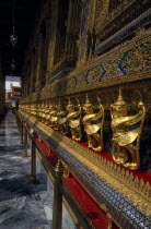 Grand Palace with Perspective of golden figures at side of Temple of Emerald Buddha.