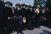 Harrow School boys wearing straw boaters and tail suits at Speech Day