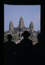 The central complex seen through the entrance gate with the silhouette of tourist crowds at Chinese New YearAsian Cambodian Kampuchea Religion Southeast Asia History Holidaymakers Kamphuchea Religiou...