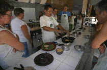 Cookery class at Time For Lime on Klong Dao beach. Instructor demonstrating the use of a wok to touristsAsian Beaches Prathet Thai Raja Anachakra Thai Resort Sand Sandy Seaside Shore Siam Southeast A...