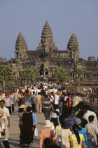 Tourists on stone causeway leading to temple complex.  Many Cambodians visiting during Chinese New Year. Asian Kampuchea Religion Southeast Asia History Holidaymakers Kamphuchea Religious Tourism