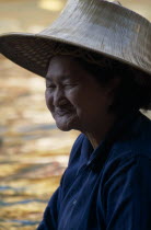 Damnoen Saduak Floating Market portrait of an old female vendor wearing a straw hatAsian Prathet Thai Raja Anachakra Thai Siam Southeast Asia Siamese