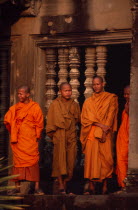 Buddhist monks standing in front of window of upper level gallery.Asian Cambodian Kampuchea Religion Southeast Asia History Kamphuchea Religion Religious Buddhism Buddhists