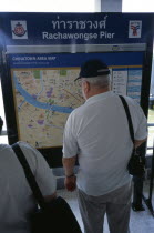 Tourist at Rachawongse Pier looking at a map of ChinatownAsian Prathet Thai Raja Anachakra Thai Siam Southeast Asia Chinese Holidaymakers Siamese Sightseeing Tourism Tourists