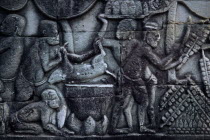The Bayon.  Bas relief carvings on the south wall depicting everyday scenes.  Cooking wild boar in a kitchen.Asian Cambodian Kampuchea Southeast Asia History Kamphuchea