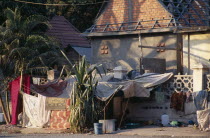 Homeless man washing clothes in a bowl outside his pavement shackAsian Cambodian Kampuchea Southeast Asia Clean Cleaning Kamphuchea Laundry Male Men Guy Cleansing Laundering Male Man Guy