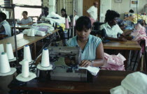 Workers at sewing machines on floor of Eagle Garment Company.