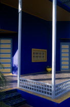 The Jardin Majorelle owned by Yves St Laurent.  Corner of balcony with walls painted vivid blue.