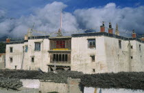 Present palace of King Jigme Palbar Bista.  Exterior with flat roof  shrine and prayer flags.