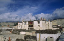 Present palace of King Jigme Palbar Bista.  Exterior with flat roof  shrine and prayer flags.