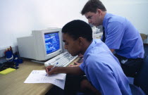 Boys in computer studies lesson at High School.African Immature Kids Learning Lessons Teaching Young Unripe Unripened Green