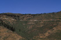 Distant view towards UN relief convoy of World Food Programme trucks on high Asmara - Massawa road.United Nations  WFP  African Eastern Africa Ertra Mits iwa