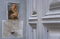 Collection box for Saint Anthony in a doorway on Republic Street with a small painting of the saint above
