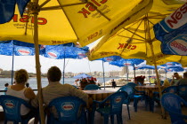 Passengers waiting for the ferry to Sliema under sunshade umbrellas on the waterfront