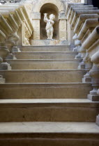 The Silent City. Statue of a cherub at the top of stone steps in the Fontanella Tearooms garden