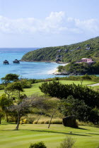 Raffles Resort Trump International Golf Course designed by Jim Fazio. The 7th fairway and 6th green with the pink Villa Juliet and Amrita Spa beyond on Godahl beach