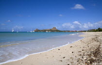 Pigeon Island National Historic Park seen from a nearby beach on a causeway to the island with yachts at anchor in Rodney Bay