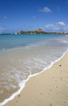 Pigeon Island National Historic Park seen from a nearby beach on a causeway to the island with yachts at anchor in Rodney Bay