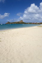 Pigeon Island National Historic Park seen from a nearby beach on a causeway to the island with yachts at anchor in Rodney Bay