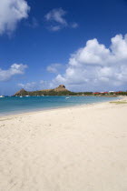 Pigeon Island National Historic Park seen from a nearby beach on a causeway to the island with yachts at anchor in Rodney Bay