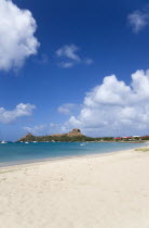 Pigeon Island National Historic Park seen from a nearby beach on a causeway to the island with yachts at anchor in Rodney Bay