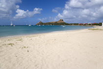Pigeon Island National Historic Park seen from a nearby beach on a causeway to the island with yachts at anchor in Rodney Bay
