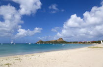Pigeon Island National Historic Park seen from a nearby beach on a causeway to the island with yachts at anchor in Rodney Bay