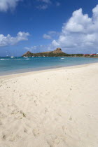 Pigeon Island National Historic Park seen from a nearby beach on a causeway to the island with yachts at anchor in Rodney Bay