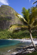 Val des Pitons The white sand beach at the Jalousie Plantation Resort Hotel with the volcanic plug of Petit Piton beyond and tourists on sunbeds beneath palapa sun shades