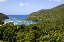 Marigot Bay with boats at anchor in the harbour below lush hillside vegetation