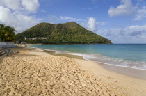 Reduit Beach in Rodney Bay during the early morning with tourists walking by the waterline