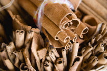 Market spice stall with cinnamon or cassia bark herbs tied in bundles