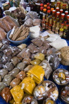 Market stall with packets of locally produced herbs  spices and bottles of sauces