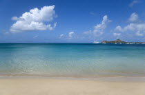 View out to sea from Reduit Beach in Rodney Bay towards Pigeon Island with yachts at anchor in the bay