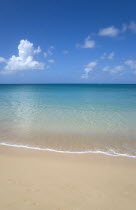 View out to sea from Reduit Beach in Rodney Bay with a yacht sailing on the horizon