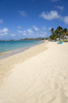 Reduit Beach in Rodney Bay with tourists in the water and on the beach with yachts at anchor in the bayCaribbean West Indies Windward Islands Beaches Holidaymakers Resort Sand Sandy Scenic Seaside Sh...