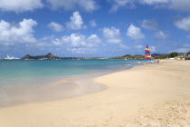 Reduit Beach in Rodney Bay with tourists in the water and on the beach with yachts at anchor in the bay