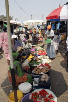 Bakau Market  Atlantic Road.  Busy market scene with women selling fruit and vegetables. SerecundaSerekuntaSerecuntaSerekudaAfricanFemale Woman Girl Lady Gambian Western Africa