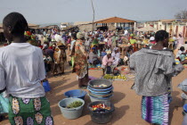 Busy market scene with women selling fruit and vegetables and coloufully dressed crowd.TanjihTanjeh  AfricancolourcolorFemale Woman Girl Lady Gambian Western Africa