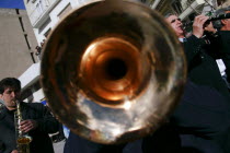 Greek street musicians playing their instruments at the celebration of the traditional Kozani carnival called Fanoi.  Trumpet player in imediate foreground.clarinetsaxophoneperformanceculturesoun...