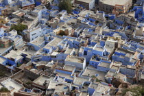 Aerial view over flat rooftops of the blue painted houses of the Brahman neighbourhood from Meherangarh Fort  known as the Blue City.castepriestBrahmanismBrahminbuildingsAsia Asian Bharat Inde...