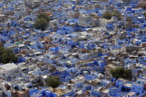 Elevated view across flat rooftops of blue painted houses of the Brahmin neighbourhood from Meherangarh Fort.BrahmanismPriestcastebuildingsculturecolourcolorAsia Asian Bharat Inde Indian Intiy...