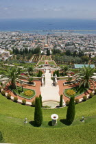 Zionism Avenue.  View of Bahai Shrine and Gardens designed as a memorial to the founder of the Baha i faith.  Tiered gardens and pathways with palms and cypress trees  central domed shrine and city be...