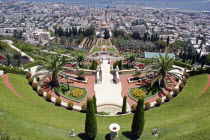 Zionism Avenue.  View of Bahai Shrine and Gardens  tiered formal gardens with pathways  palms and cypress trees with central shrine and city beyond.sanctuarypilgimagesacredreligionmonothesistic f...