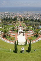 Zionism Avenue.  View of Bahai Shrine and Gardens built as a memorial to the founder of the Baha i faith.  Tiered  formal gardens  palms and cypress trees  central domed shrine and city and distant po...