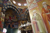 Nazareth.  Interior of the Greek Orthodox Church of St. Gabriel also known as the Church of the Annunciation  part view of domed roof and archways decorated with paintings of biblical scenes and the s...