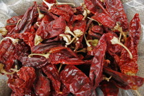 Jerusalem food market.  Open sack of dried  red  hot chili peppers  close cropped view filling frame.chillichilieschilliescapsicumfruitvegetablespicetastecookcookingcuisineIsra el Israeli...