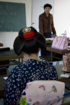 Gion District  the neighbourhood where Geisha live  study and perform.  Geisha  wearing a kimono and obi attending an English class and talking to the teacher at Mia Garatso school for Geisha and maik...