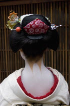 Gion District.  Head and shoulders of Geisha  photographed with back to camera showing neck and shoulders painted white except for part of accentuated nape  left unpainted and considered sensuous.  Ha...