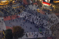 Shibuya District.  Meiji-dori with Dogen-Zaka junction outside Shinjuku Station.  View from above over one of the busiest junctions in the world with crowds on pedestrian crossings  waiting traffic an...